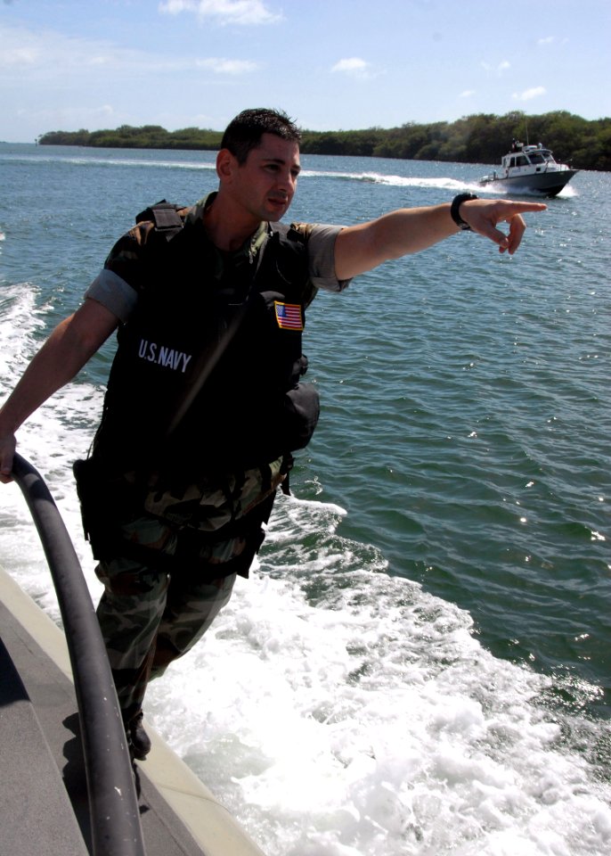 US Navy 080130-N-9758L-085 Master-at-Arms 2nd Class Danny Hebri, assigned to Harbor Security on board Naval Station Pearl Harbor, directs a Seaark Dauntless security boat towards a target while patrolling the Harbor
