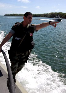 US Navy 080130-N-9758L-085 Master-at-Arms 2nd Class Danny Hebri, assigned to Harbor Security on board Naval Station Pearl Harbor, directs a Seaark Dauntless security boat towards a target while patrolling the Harbor