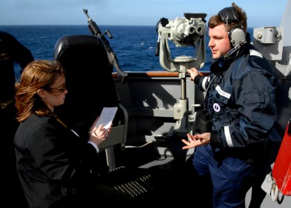 US Navy 080127-N-7981E-388 While standing watch aboard the USS Momsen (DDG 92), Boatswain's Mate Seaman Alden Fenton discusses some of the training he has received to help him spot and identify marine mammals with a journalist