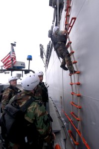 US Navy 080205-N-0807W-115 Sailors assigned to the visit, board, search and seizure team from the dock landing ship USS Harpers Ferry (LSD 49), board the Military Sealift Command fleet replenishment oilier USNS Pecos (T-AO 197)