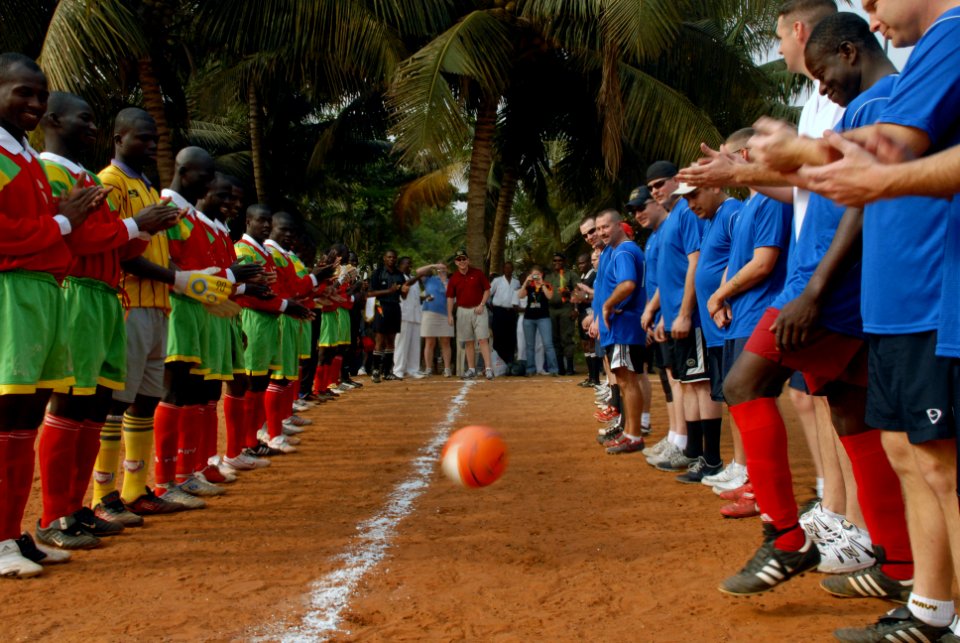 US Navy 080128-N-0193M-422 Rear Adm. Anthony Kurta kicks out the first ball at a soccer game between members of the Togolese 1st Infantry Regiment and Sailors stationed aboard the high speed vessel (HSV) 2 Swift