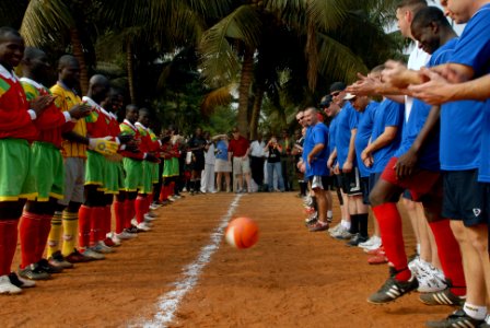 US Navy 080128-N-0193M-422 Rear Adm. Anthony Kurta kicks out the first ball at a soccer game between members of the Togolese 1st Infantry Regiment and Sailors stationed aboard the high speed vessel (HSV) 2 Swift