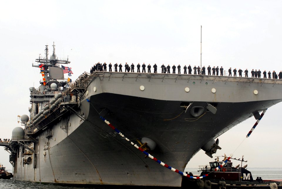 US Navy 080201-N-5307M-039 Sailors aboard the amphibious assault ship USS Kearsarge (LSD 3) man the rails as the ship returns to homeport
