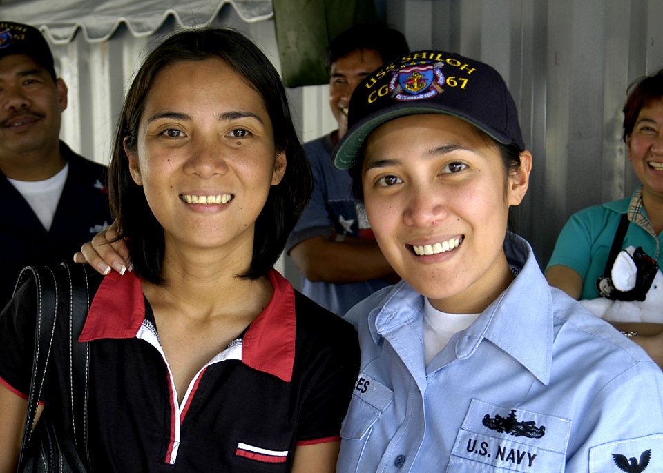 US Navy 080201-N-4649C-051 Storekeeper 3rd Class Gidel Torres reunites with one of her seven sisters aboard the guided-missile cruiser USS Shiloh (CG 67) during a port visit in Manila