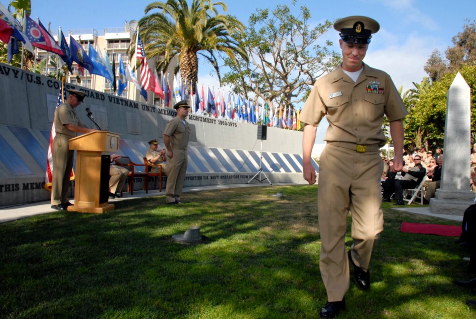 US Navy 080201-N-9909C-003 Chief Culinary Specialist Jaret Elliott returns to his seat after giving the first salute to Ensign Steve Klinshaw during Klinshaw's commissioning ceremony at the Naval Amphibious Base