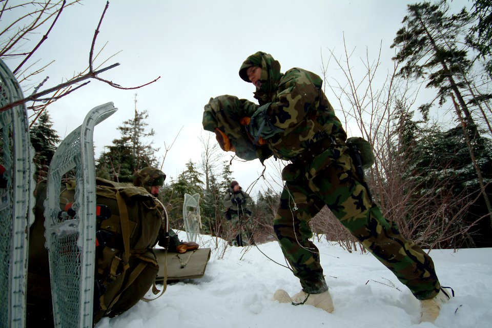 US Navy 080203-N-0411D-053 A student at the Navy Survival, Evasion, Resistance and Escape (SERE) school repacks his gear after a lesson