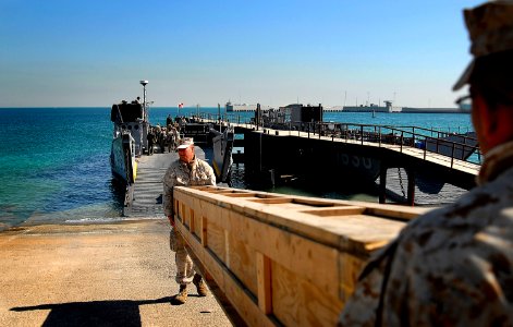 US Navy 080204-N-4774B-326 Marines of the 11th Marine Expeditionary Unit load supplies bound for amphibious assault ship USS Tarawa (LHA 1) onto a landing craft utility