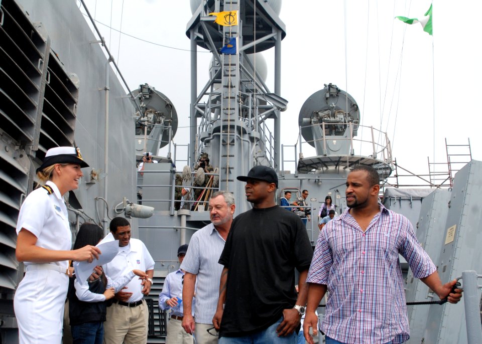 US Navy 080203-N-5476H-039 Public affairs officer Lt. j.g. Michelle Westhoff takes San Diego Chargers teammates Carlos Polk, left, and Lorenzo Neal on a tour of the Ticonderoga-class guided-missile cruiser USS Chosin (CG 65)
