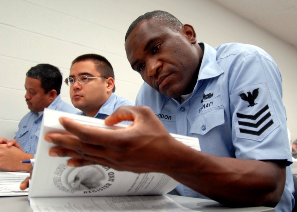 US Navy 080205-N-9758L-023 Religious Program Specialist 1st Class Rubert Cleridor, assigned to Naval Submarine Support Center Pearl Harbor, reads the 2008-09 voting assistance guide during a Federal Voting Assistance Program wo