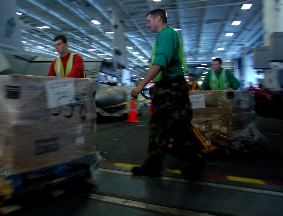 US Navy 080209-N-4879G-174 Sailors of the Nimitz class aircraft carrier USS Harry S. Truman (CVN 75) dolly supplies through Hangar Bay 2 during a replenishment at sea evolution