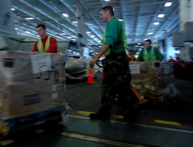 US Navy 080209-N-4879G-174 Sailors of the Nimitz class aircraft carrier USS Harry S. Truman (CVN 75) dolly supplies through Hangar Bay 2 during a replenishment at sea evolution