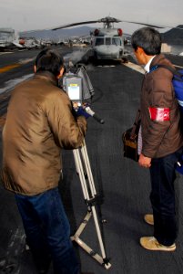 US Navy 080211-N-9760Z-089 Japanese media document the flight deck of the aircraft carrier USS Nimitz (CVN 68) during a port visit to Sasebo