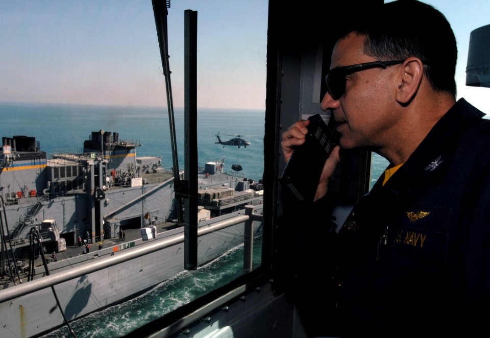 US Navy 080209-N-8923M-003 Capt. Herman Shelanski, commanding officer aboard the Nimitz-class aircraft carrier USS Harry S. Truman (CVN 75), observes operations from the bridge during a vertical replenishment