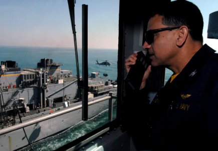 US Navy 080209-N-8923M-003 Capt. Herman Shelanski, commanding officer aboard the Nimitz-class aircraft carrier USS Harry S. Truman (CVN 75), observes operations from the bridge during a vertical replenishment