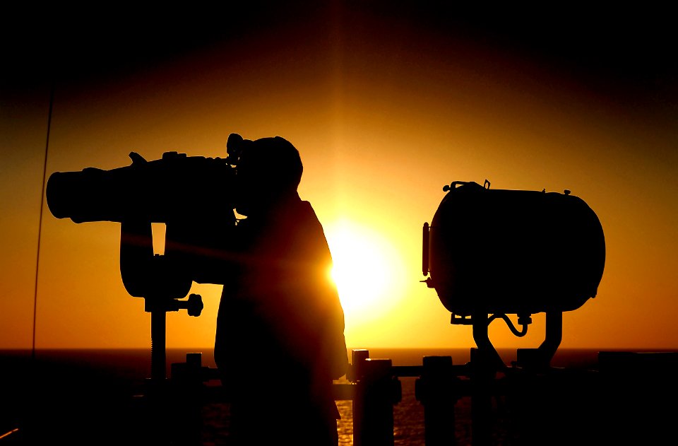 US Navy 080212-N-4774B-026 Seaman Roger Giangrande stands watch aboard amphibious assault ship USS Tarawa (LHA 1) as dawn breaks over the Persian Gulf