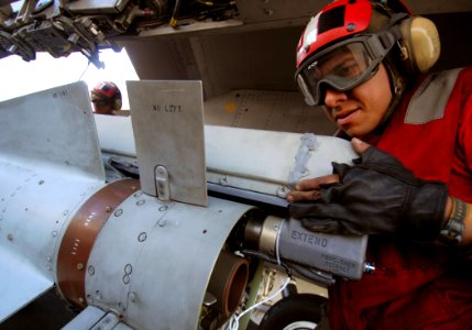 US Navy 080206-N-2984R-064 An aviation ordinanceman works on the launch mechanism of an AGM-65 Maverick air-to-surface missile aboard the Nimitz-class aircraft carrier USS Harry S. Truman (CVN 75)