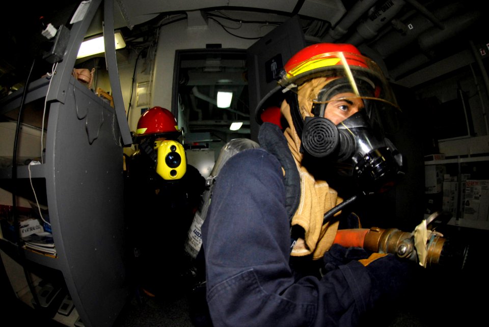 US Navy 080206-N-8546L-078 Sailors aboard the amphibious command ship USS Blue Ridge (LCC 19) conduct a shipboard fire training exercise in the ship's print shop during a general quarters drill