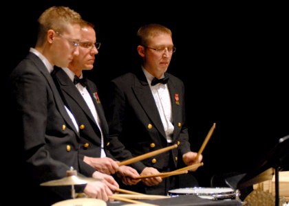 US Navy 080211-N-0773H-061 Musicians 1st class Jason W. Niehoff, left, Curt R. Duer and John J. Martinich, all members of the percussion section, perform on stage during a concert presented at Great Mills High School