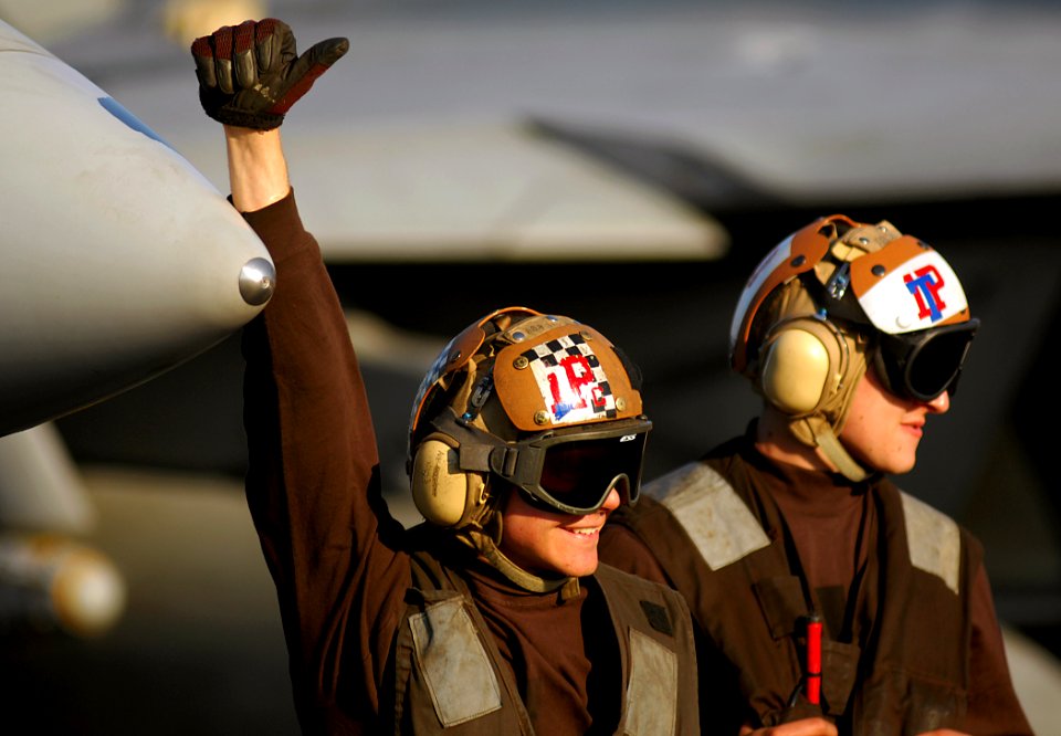 US Navy 080206-N-2984R-322 A plane captain gives a thumbs-up sign aboard the Nimitz-class aircraft carrier USS Harry S. Truman (CVN 75)
