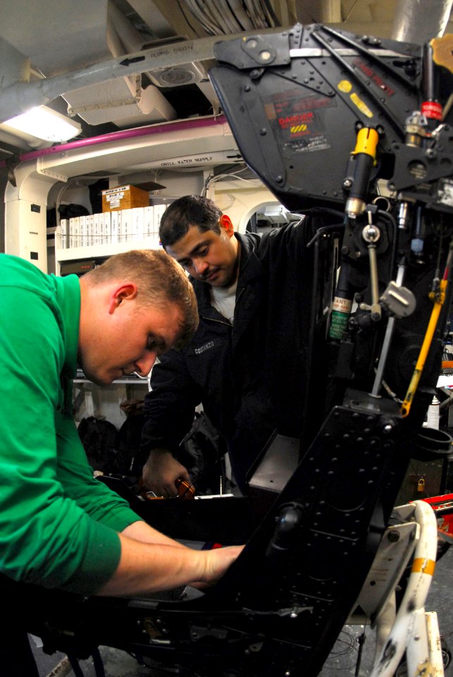 US Navy 080206-N-9760Z-019 Aviation Structural Mechanic (Equipment) 2nd Class Jason Stables, left, and Aviation Structural Mechanic (Equipment) 2nd Class Mario Costanzo assemble an ejection seat aboard the nuclear-powered aircr