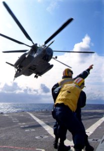 US Navy 080213-N-0807W-354 Boatswain's Mate 2nd Class Cariglo A. Rula, directs a CH-53E Super Stallion helicopter during training operations aboard the dock landing ship USS Harpers Ferry (LSD 49) photo
