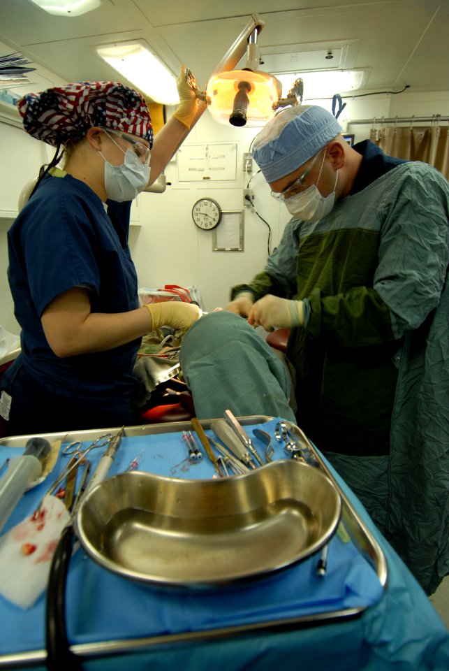 US Navy 080207-N-6326B-163 Hospitalman Anna Lupson, left, and Lt. Jose Suris extract a wisdom tooth in the dental ward of the nuclear-powered aircraft carrier USS Nimitz (CVN 68)