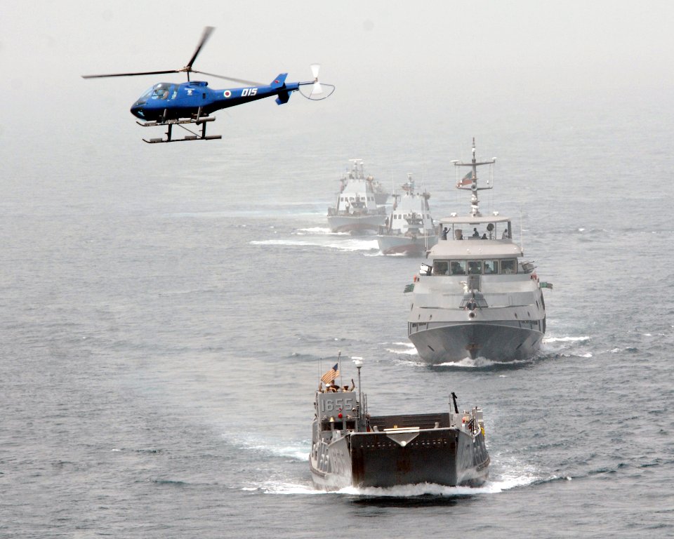 US Navy 080202-N-8933S-006 Landing Craft Utility (LCU) 1655 leads the Equatorial Guinea Navy in formation behind Africa Partnership Station (APS) flagship USS Fort McHenry (LSD 43), a dock landing ship, as they pass along the E