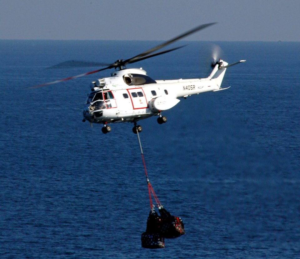 US Navy 080207-N-8335D-143 An EH-96 Puma helicopter from Military Sealift Command dry cargo-ammunition ship USNS Sacagawea (T-AKE 2) transports supply pallets to the amphibious assault ship USS Tarawa (LHA 1)