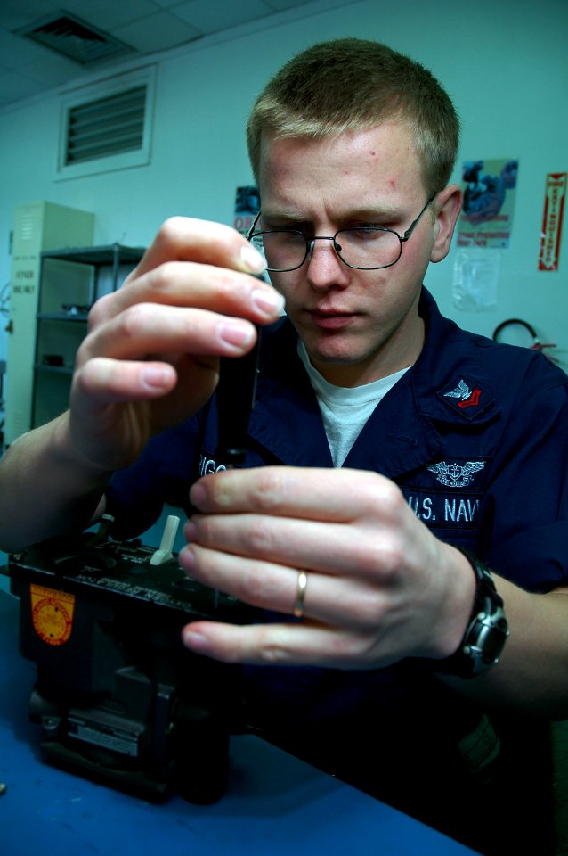 US Navy 080212-N-5821P-006 Aircrew Survival Equipmentman 2nd Class Brock Riggen rebuilds an oxygen regulator in the aircraft intermediate maintenance department at Naval Air Station Sigonella