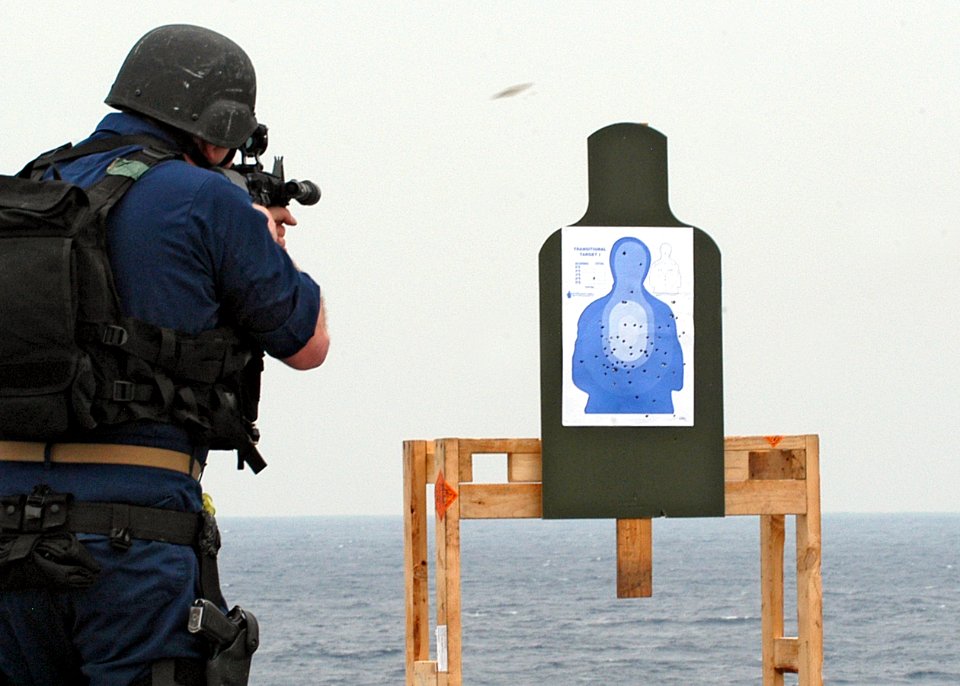 US Navy 080204-N-0807W-084 A member of the visit, board, search and seizure (VBSS) security force aboard the amphibious dock landing ship USS Harpers Ferry (LSD 49) fires his weapon on the firing range during a target practice