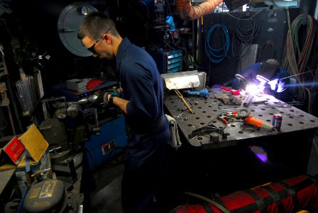 US Navy 080205-N-9760Z-002 Hull Maintenance Technician Fireman Brandon Oesch works on a toolbox holder in the repair shop aboard the nuclear-powered aircraft carrier USS Nimitz (CVN 68)