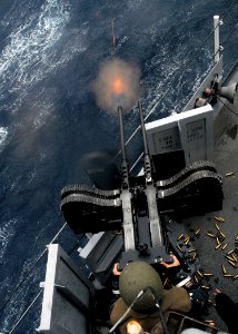 US Navy 080209-N-5067K-299 A gunner stationed aboard the amphibious transport dock ship USS Juneau (LPD 10) fires a twin 50-caliber machine-gun during a live fire training exercise