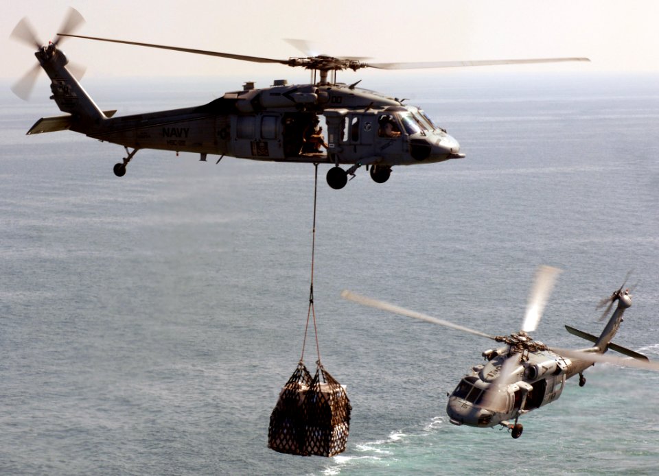 US Navy 080209-N-8923M-071 An MH-60S Seahawk attached to the Sea Knights of Helicopter Sea Combat Squadron (HSC) 22 transfers cargo from the Military Sealift Command fast combat support ship USNS Arctic (T-AOE 8)