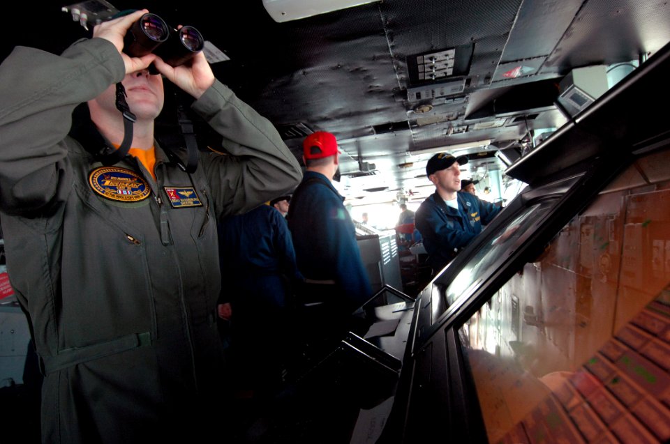US Navy 080209-N-8923M-041 Lt. Walter Massenburg searches for surface contacts from the bridge aboard the Nimitz-class aircraft carrier USS Harry S. Truman (CVN 75)