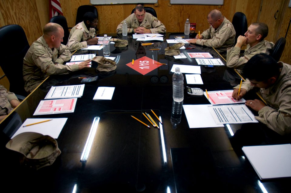 US Navy 080210-N-7367K-006 Senior Chief Builder James Walley, center, a Seabee assigned to Naval Mobile Construction Battalion (NMCB) 15, Task Force Sierra Det. 1, goes over the administrative data of the advancement exam