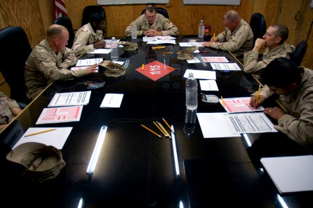 US Navy 080210-N-7367K-006 Senior Chief Builder James Walley, center, a Seabee assigned to Naval Mobile Construction Battalion (NMCB) 15, Task Force Sierra Det. 1, goes over the administrative data of the advancement exam