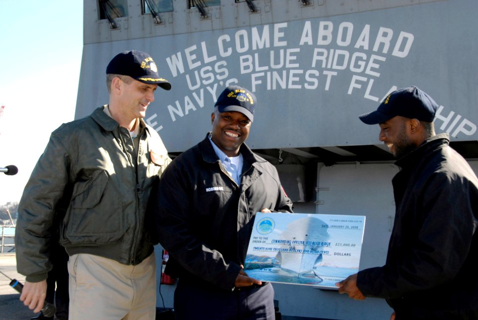 US Navy 080215-N-8546L-037 Capt. David A. Lausman, commanding officer of the amphibious command ship USS Blue Ridge (LCC 19), presents a check for $25,000 toward the ship's Morale, Welfare and Recreation (MWR) program