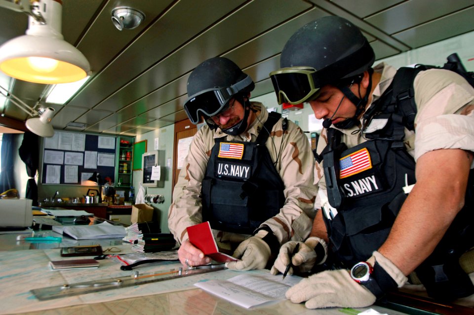 US Navy 080206-N-2420K-199 Chief Gunner's Mate Curtis Staybrook, left, boarding officer, and his assistant boarding officer, Gunner's Mate 2nd Class Johnpaul Candelaria, members of the visit, board, search, and seizure team of