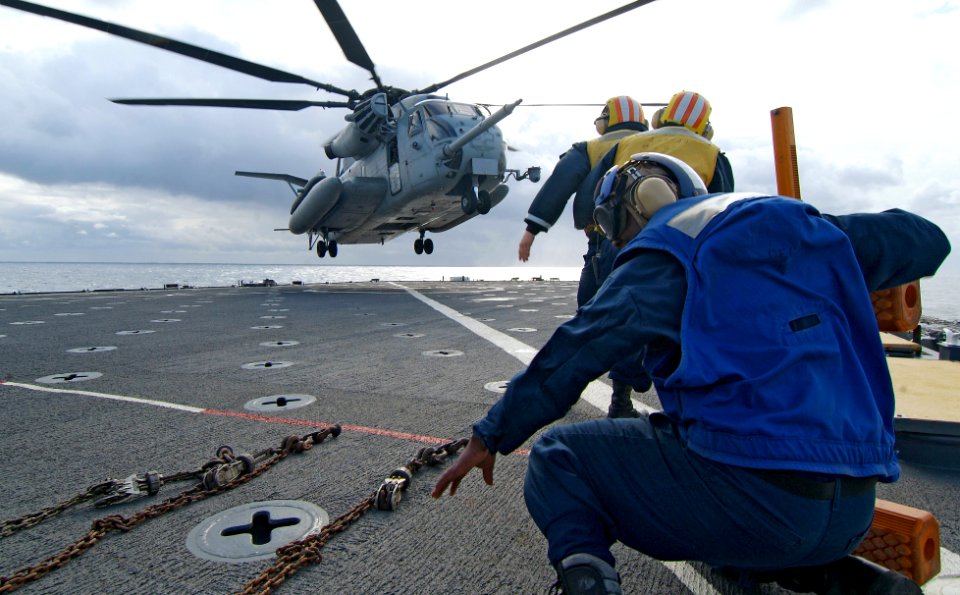 US Navy 080213-N-0807W-175 Sailors prepare to chalk and chain a CH-53E Super Stallion helicopter attached to Medium Helicopter Squadron (HMM) 265 ) to the flight deck of the dock landing ship USS Harpers Ferry (LSD 49) during t