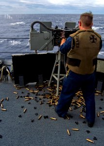 US Navy 080216-N-5253W-004 Gunner's Mate 2nd Class Jami Kilmer of the Arleigh Burke-class guided-missile destroyer USS Fitzgerald (DDG 62) fires dual .50-caliber machine guns