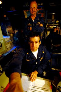 US Navy 080216-N-5476H-061 Capt. Randall Hendrickson, commanding officer of the Ticonderoga-class guided-missile cruiser USS Lake Erie (CG 70), watches as Lt. Cmdr. Andrew Bates operates the radar system control