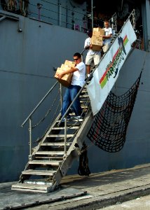 US Navy 080213-N-0577G-017 Africa Partnership Station (APS) Sailors carry Project Handclasp medical supplies down the brow of the amphibious dock landing ship USS Fort McHenry (LSD 43) for donation to the Ghanaian Navy Western