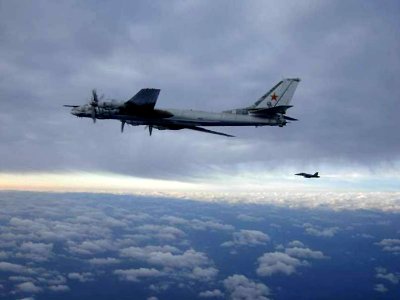US Navy 080209-N-XXXXX-001 An F-A-18 Hornet from Carrier Air Wing (CVW) 11, embarked aboard the aircraft carrier USS Nimitz (CVN 68) escorts a Russian Tu-95 Bear