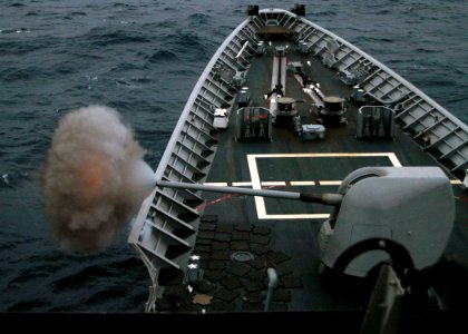 US Navy 080209-N-4649C-001 An Mk 45 Mod 4 Gun system fires off the bow of the guided-missile cruiser USS Shiloh (CG 67) during surface gunnery exercises photo