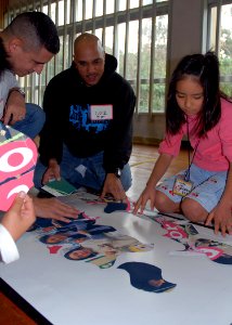 US Navy 080214-N-8547M-023 Chief Intelligence Specialist Greg Diaz and Religious Programs Specialist 3rd Class Cosme Rosete, both of Naval Mobile Construction Battalion (NMCB) 5, help students of Higa Elementary School learn En