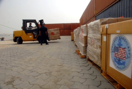 US Navy 080211-N-0193M-010 High speed vessel Swift (HSV 2) Sailors unload 27 pallets of food, medical supplies and hygiene products as part of Project Handclasp photo