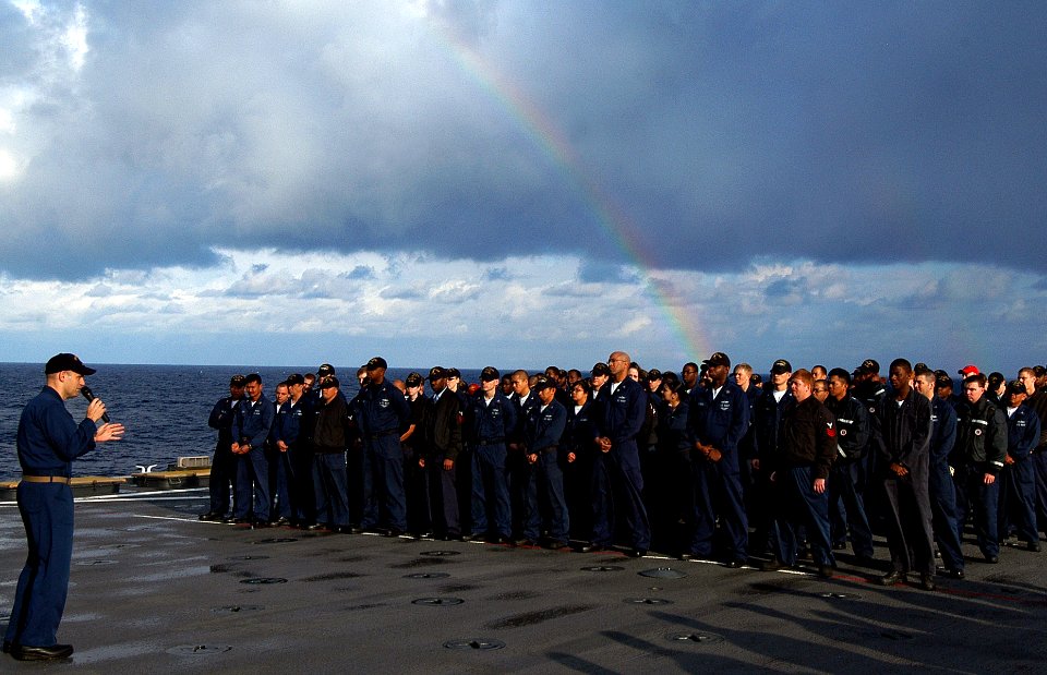 US Navy 080215-N-0807W-060 A rainbow breaks over Sailors mustering for an underway replenishment aboard the amphibious assault ship USS Harpers Ferry (LSD 49)