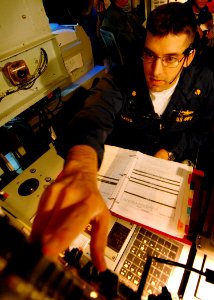 US Navy 080216-N-5476H-054 Lt. Cmdr. Andrew Bates operates the radar system control in the combat information center during a ballistic missile defense drill aboard the Ticonderoga-class guided-missile cruiser USS Lake Erie (CG