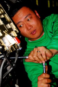 US Navy 080216-N-9760Z-004 Aviation Machinist's Mate 2nd Class Charles Wang, assigned to the