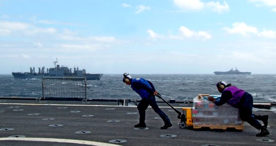 US Navy 080216-N-0807W-608 Sailors assigned to the dock landing ship USS Harpers Ferry (LSD 49), move supplies off the flight deck during a vertical replenishment from the Military Sealift Command (MSC) combat stores ship USNS